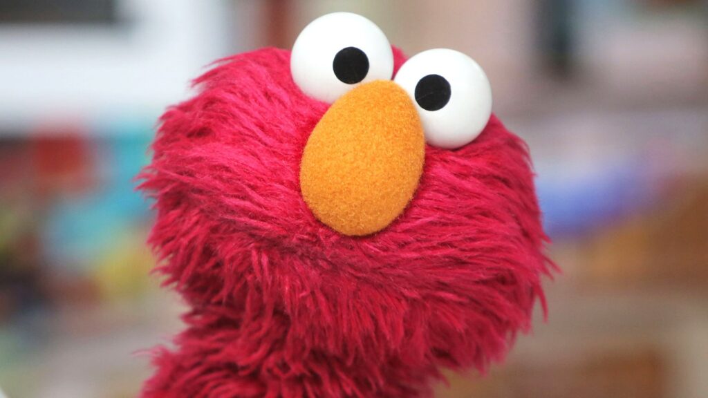 A close-up offshoot of Elmo looking straight at the viewer with an even more aggrieved, long suffering look on his face — an impressive feat for a muppet, so shout out to the Sesame Street Workshop for nailing it.